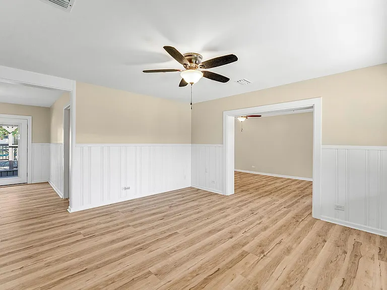 Living room leads to a game room/den and dining room.