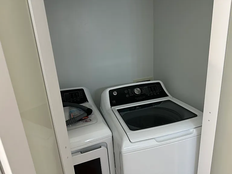 Utility room with full size washer and dryer.