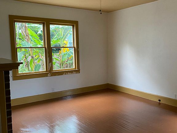 Master bed with original fireplace and half bath.