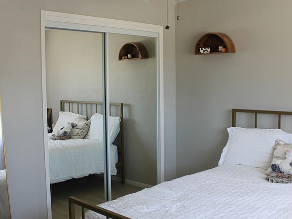 Bedroom #1 with large window, plenty of natural light and ceiling fan.