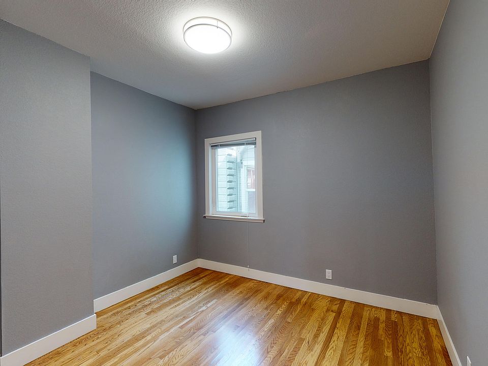 Bedroom with a window and a wood-like flooring