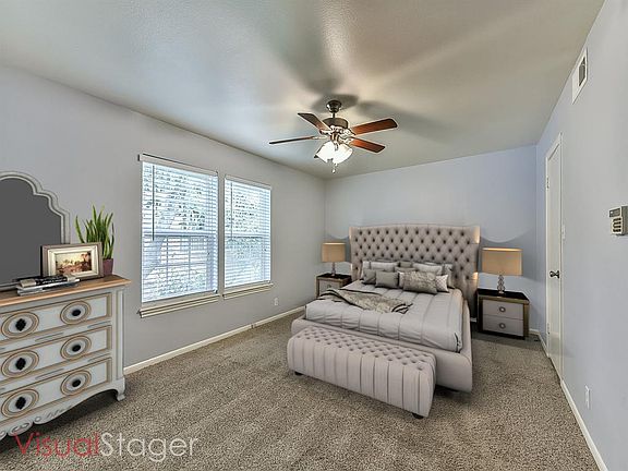 One of two oversized bedrooms upstairs. This one faces the front garden area, has a large walk in closest, and attractive paint colors. (photo has been virtually staged)