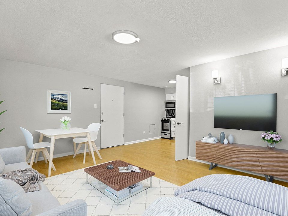 Open-concept studio layout featuring a living area and view into kitchen