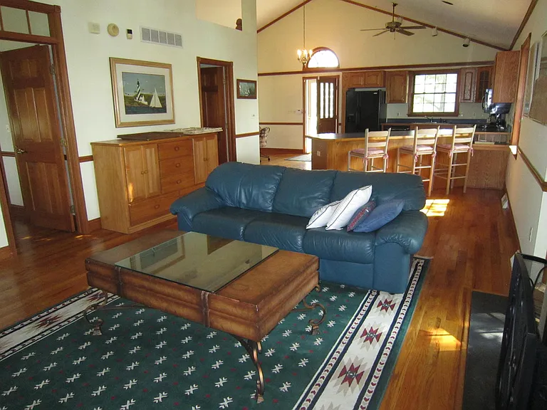 LR/Great Room facing Kitchen and Front Door w/ MBR Door, Laundry Room Door & Dining Area on left