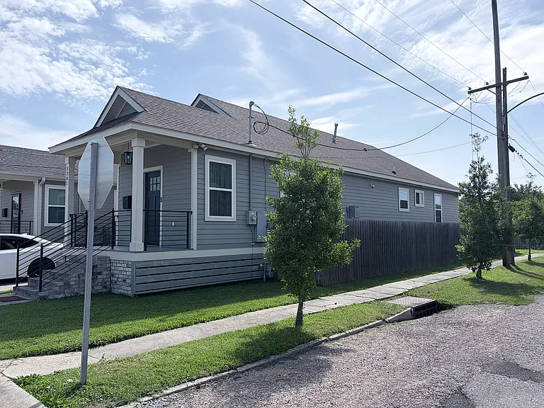 House is completely fenced on a corner lot