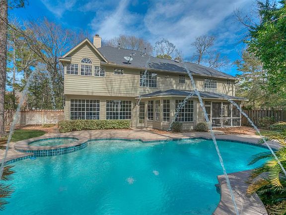 Looking to the rear of the home from the pool wall. The home is constructed of cement board and masonry (concrete) stucco!