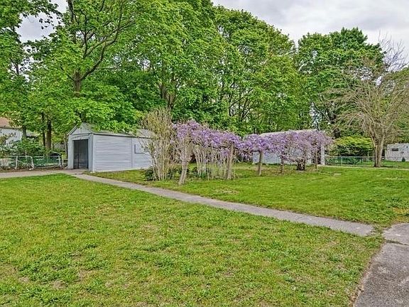 Walkway from Unit 239 driveway to back porch; structure has been removed to provide parking for 2 vehicles.
