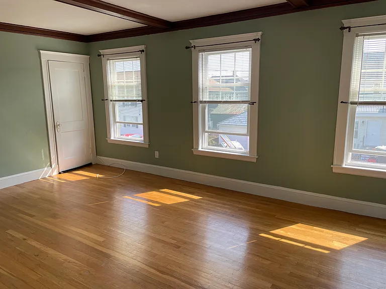 Living Room has exposed beams and plenty of light.