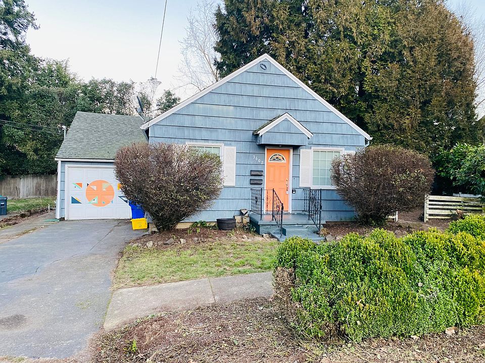 Front of house- front yard and long driveway with single car garage