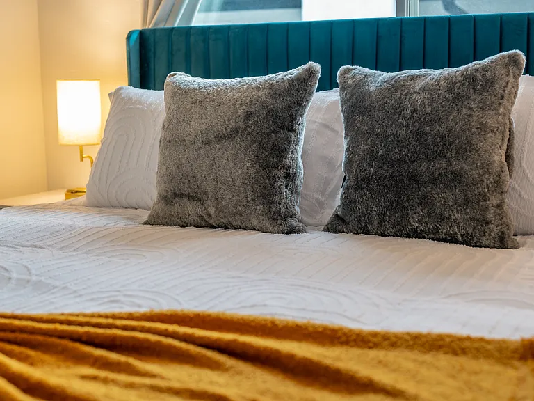 Complemented by an assortment of soft, high-quality pillows, ensuring everyone finds their perfect level of support for a restful sleep.