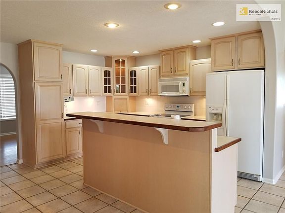 Updated kitchen with tile floor, custom cabinets, recessed lighting and undercounter lighting