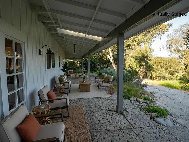 Large covered patio gives you space to entertain or take in the sunrise. Snuggle up with a good book during an occasional rainstorm. New outdoor fixtures adorn and add a beautiful magical glow to the space.