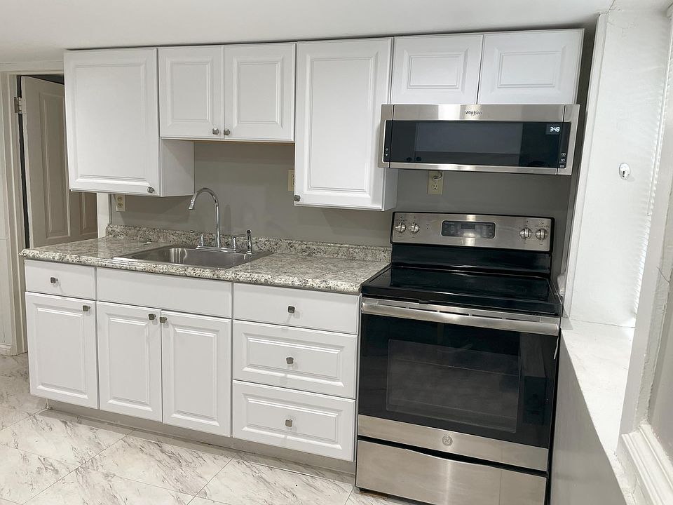 newly renovated kitchen with full sized stainless appliances, including microwave