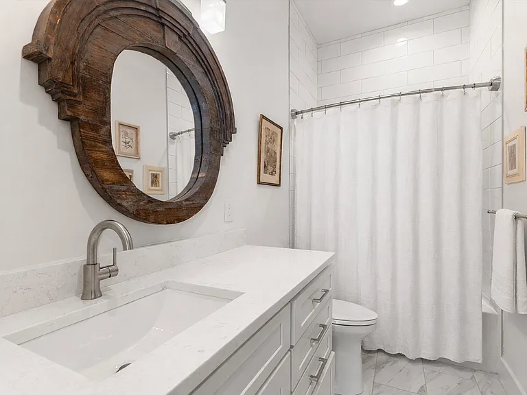 Private ensuite bath serving the main-level bedroom suite.