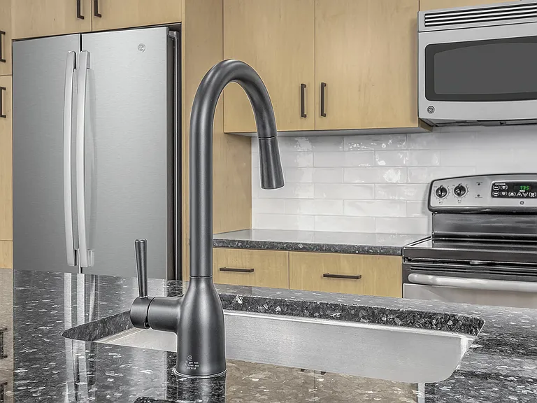 Beautifully renovated kitchens feature modern white subway tile backsplash and sleek matte black fixtures