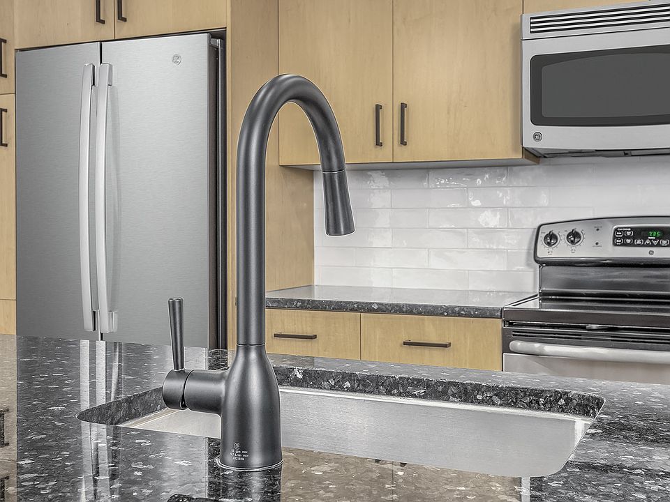 Beautifully renovated kitchens feature modern white subway tile backsplash and sleek matte black fixtures