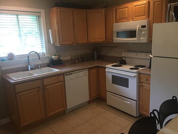 Efficient kitchen with solid surface countertops and breakfa