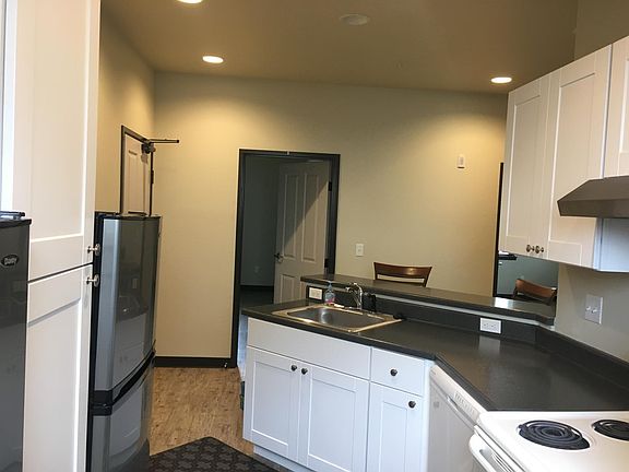 The kitchen has 3 fridges