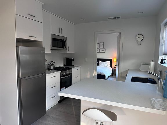 Fully equipped kitchen with gas range, microwave, refrigerator and dishwasher. In-formal counter dining.