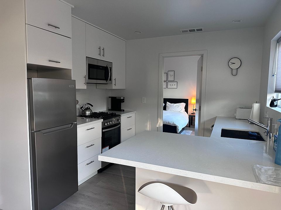 Fully equipped kitchen with gas range, microwave, refrigerator and dishwasher. In-formal counter dining.