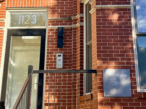 Charming brick facade and private walk-up front entry at 1123 6th Street NW, offering a secure and welcoming foyer entrance.
