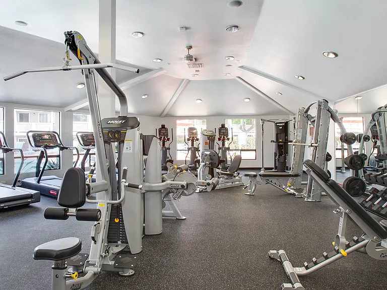 Fitness center boasts an expansive workout space with a variety of equipment