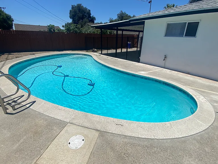 Backyard pool that has been completely updated with new equipment, tile, plumbing and plaster. Weekly pool maintenance included in rent.