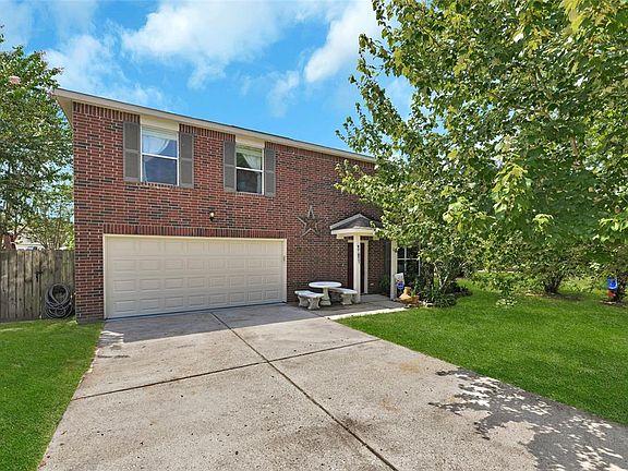 Covered front door entry and 2 car garage. New garage door (2020), garage floor epoxy coating (2016), and Container Store Elfa garage shelving & workspace (mounted).