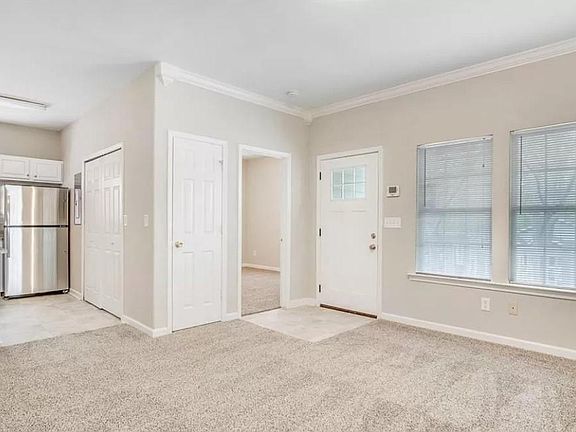 Living room with view of front bedroom & kitchen