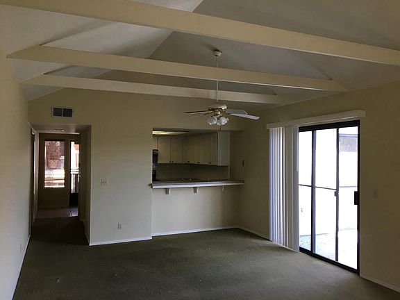 Living room with slider access to the deck. Vaulted ceilings
