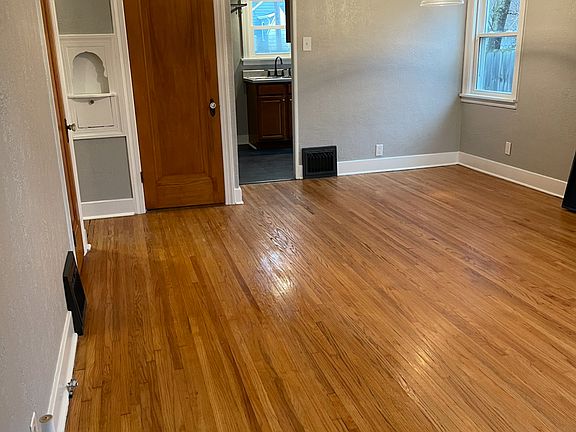 This is walking into front living area and dining room at far side. Door goes to upper level bedroom