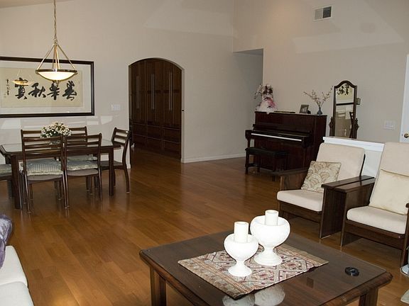 The high ceilings and open floor plan create a spacious, warm living area perfect for family time.