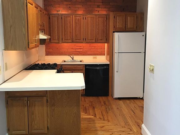 Backlit Kitchen with exposed brick + gas stove