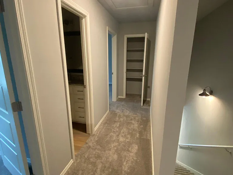 Hallway to 2 bedrooms, bathroom and linen closet
