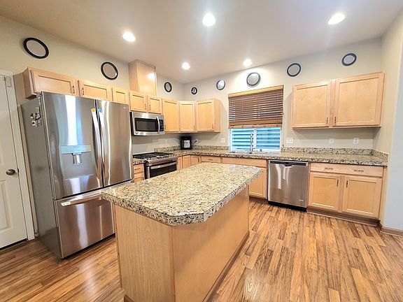 Open kitchen with all new stainless steel appliances, gas range, granite countertops and pantry. Space for breakfast table.