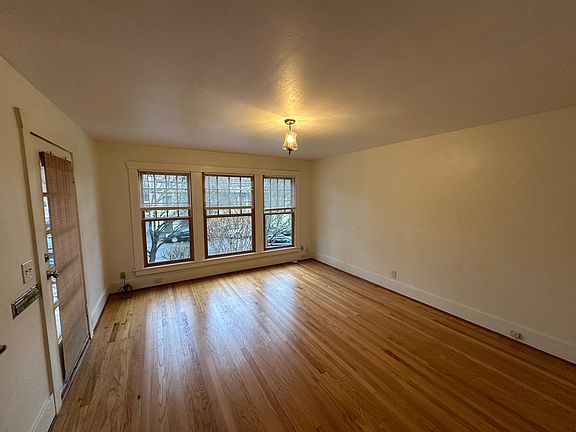 Living room with view of front door + street facing windows