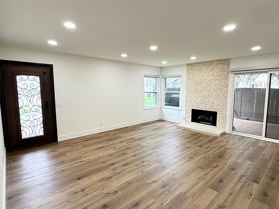 Vinyl plank flooring, recessed lighting, custom gorgeous front door