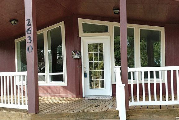 The covered front deck welcomes you, a great spot to sit and rest.