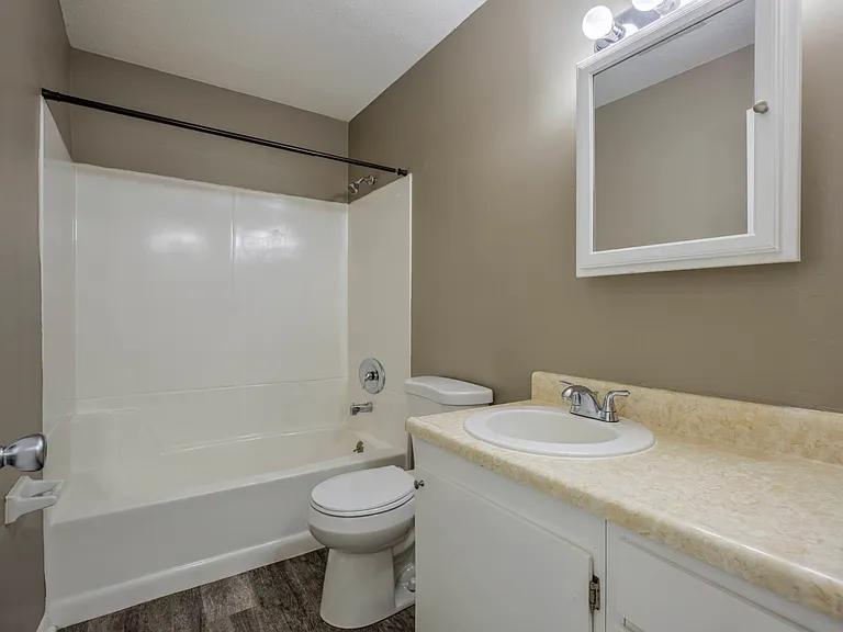 bathroom with grey walls and white finishes.