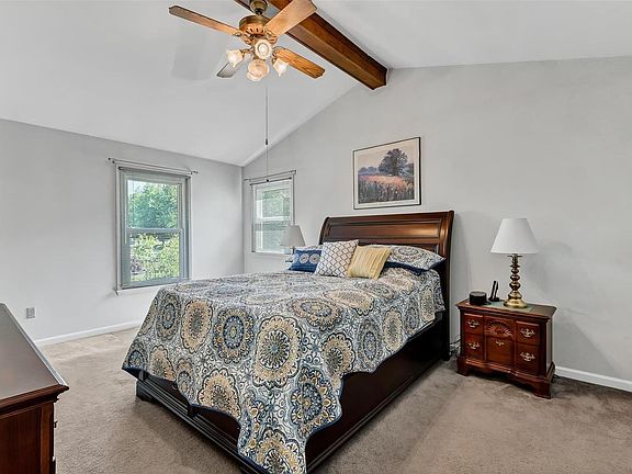 Vaulted master bedroom with two walk-in closets
