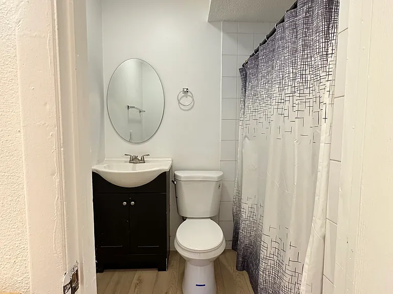 Spacious full bathroom with vanity, toilet, and shower.