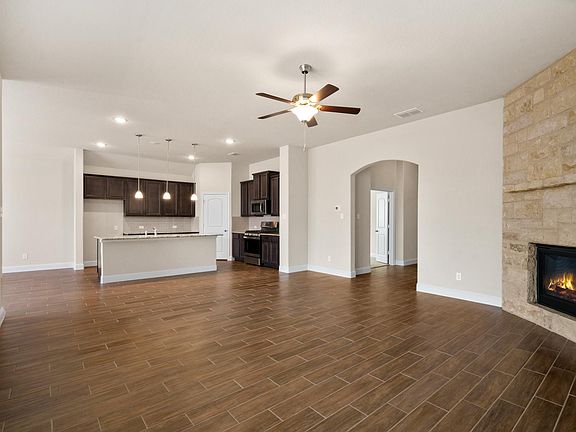 Kitchen opens to living area and gas fireplace