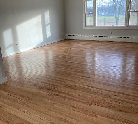Living room with south-facing picture window. There are also windows in the dining area. So much light!