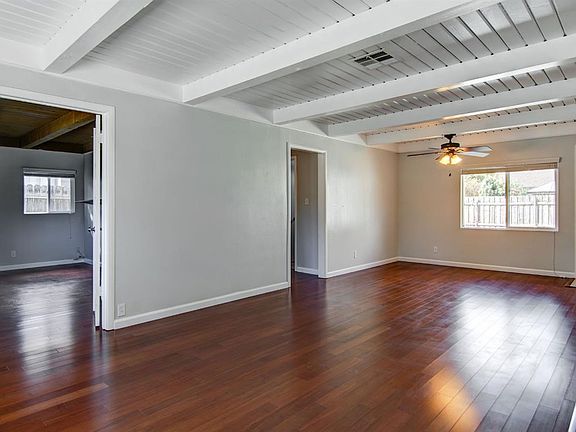 Front bedroom with glass doors to living room, ideal for a study.