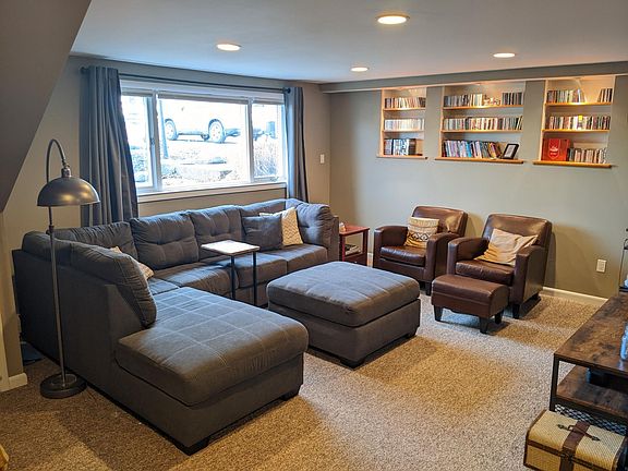 Lower family room features illuminated built-ins and makes a great home theater.
