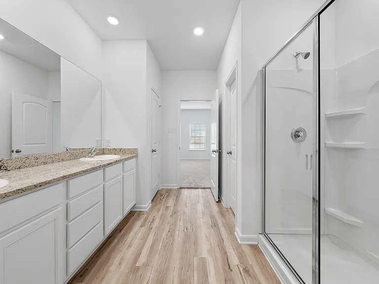 The master bedroom with a dual sink vanity.