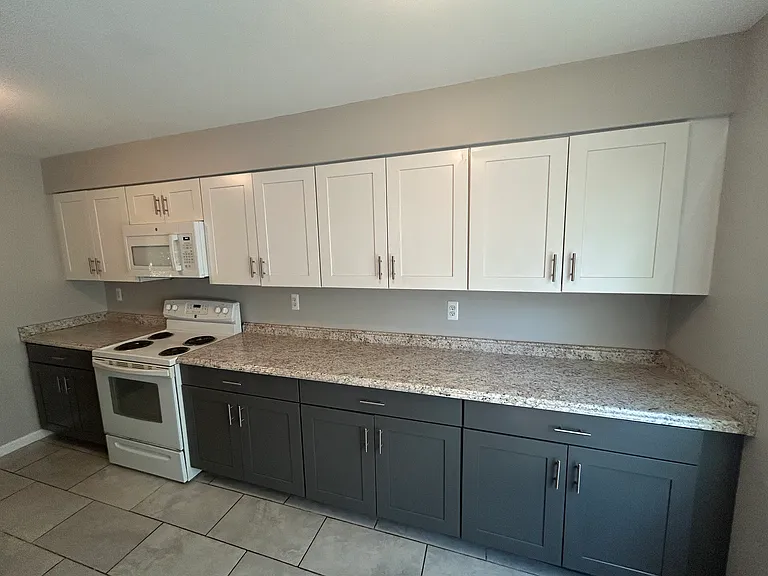 Kitchen w/ ample cabinet space. Pull out drawers in lower cabinets.