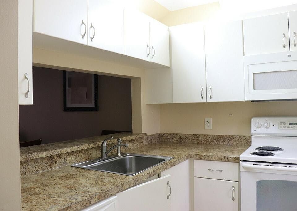 Kitchen Wood Cabinets, Dishwasher, stove, fridge, dishwasher & microwave