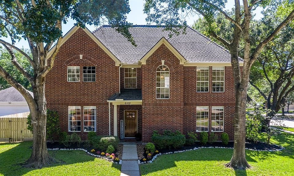 This charming home beckons visitors from the street. Stately and clad in brick with expansive windows.