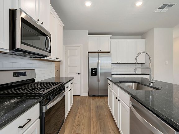 The large granite island provides extra space for chopping vegetables and cooking.